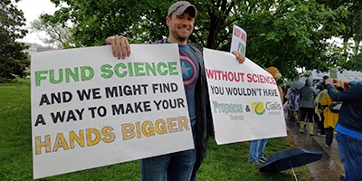 A man holding placards at the March for science, Washington DC